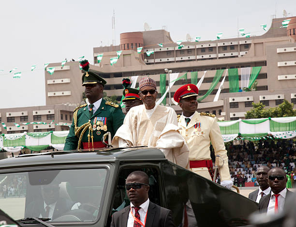 ABUJA, NIGERIA - MAY 29:  Nigeria's new President Muhammadu Buhari (C) greets the audience during his swearing in on May 29, 2015 in Abuja, Nigeria.  Buhari, a former general in the Nigerian army, had previously lead the nation for two years after a military coup in 1983. He replaces Goodluck Jonathan, who had been president since 2010. (Photo by Bennett Raglin/Getty Images)