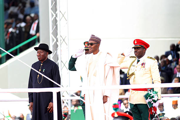 ABUJA, NIGERIA - MAY 29:  Nigeria's new President Muhammadu Buhari (C) is sworn in as outgoing president Goodluck Jonathan (L) looks on May 29, 2015 in Abuja, Nigeria.  Buhari, a former general in the Nigerian army, had previously lead the nation for two years after a military coup in 1983. He replaces Jonathan, who had been president since 2010. (Photo by Bennett Raglin/Getty Images)